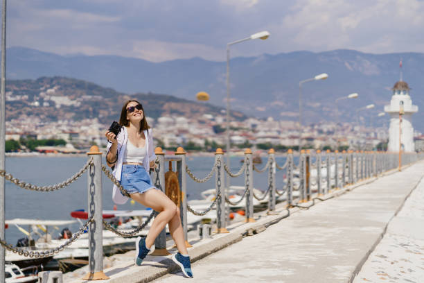istock Woman sitting by the seaside 1358300897