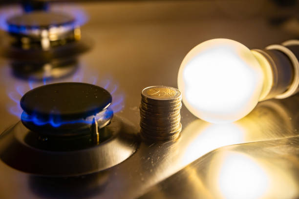 Light bulb on and gas cooker on. stock photo