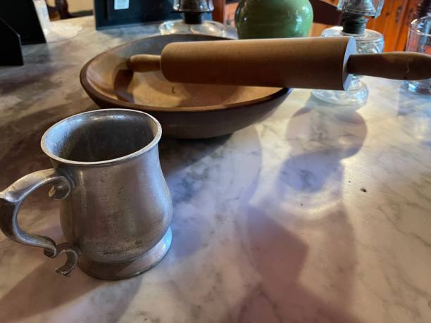 istock Old Wood bowl, rolling pin and pewter mug 1358302563