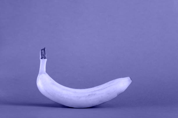 istock banana isolated on very peri color background 1358307390
