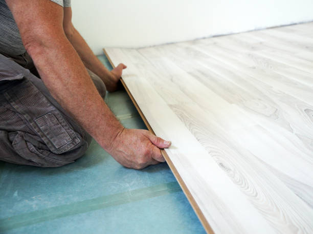 istock a worker assembles a laminate floor in a living room 1358308501