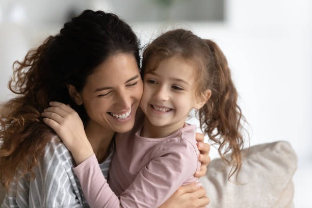 istock Sincere millennial hispanic woman cuddling cute small kid. 1358310809