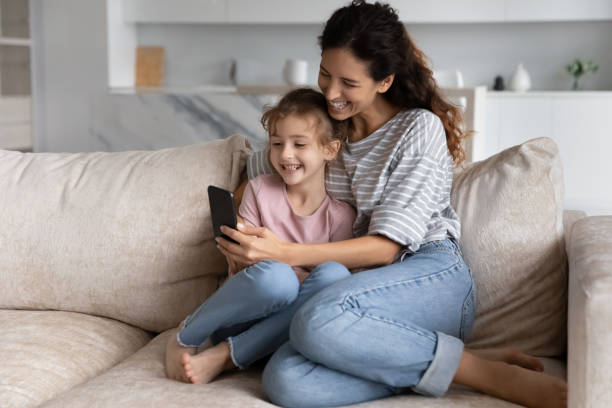 istock Happy young mother and small kid using cellphone apps. 1358310815