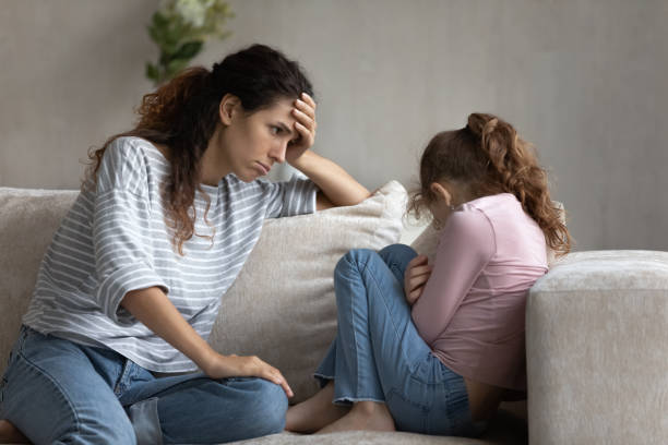 istock Young latin mother feeling guilty looking at stressed little kid. 1358310841
