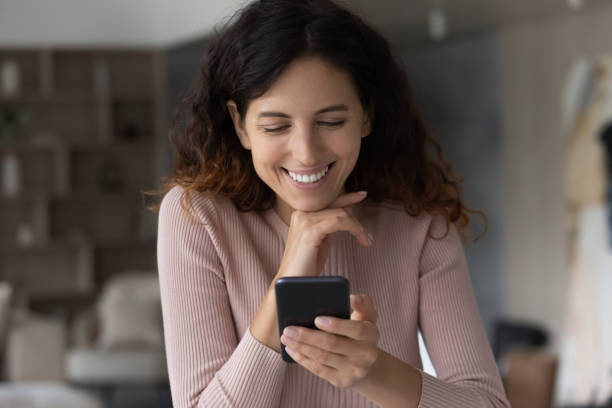 istock Happy young latin woman using cellphone at home. 1358310857