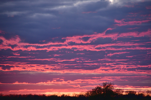 Pink, orange, and purple clouds after sunset.
