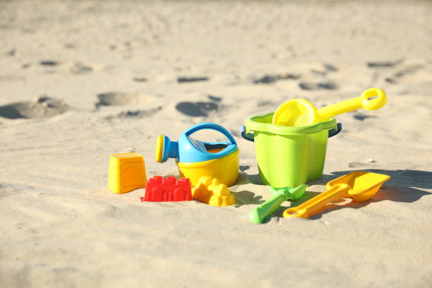 istock Different child plastic toys on sandy beach 1358319339