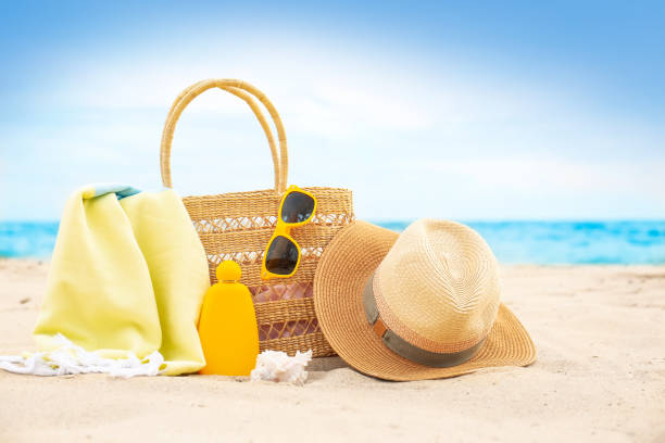 istock Different stylish beach objects and seashell on sand near sea 1358319378