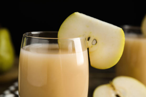istock Fresh juice with slice of pear, closeup 1358319490