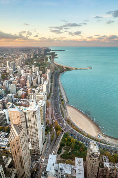 Chicago and Lake Michigan at Sunset Chicago's Lake Shore Drive and North Avenue Beach photographed from above. lake shore drive chicago stock pictures, royalty-free photos & images