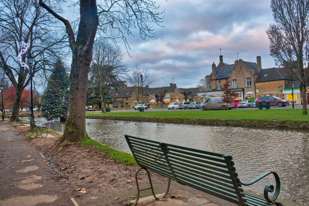 istock Bourton on the Water bench and Christmas tree 1358322332