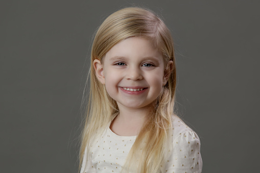 Studio portrait of smiling 4 years old girl looking at camera