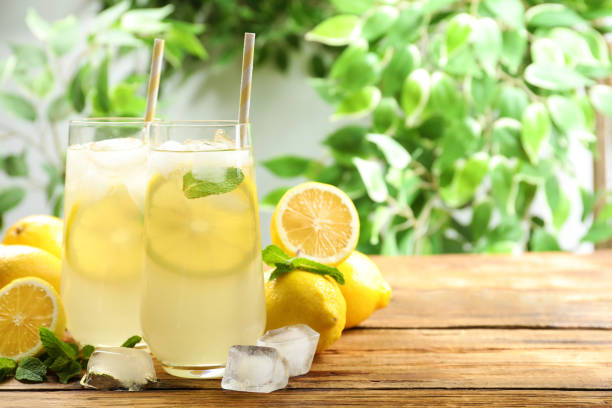istock Natural lemonade with mint on wooden table, space for text. Summer refreshing drink 1358323896