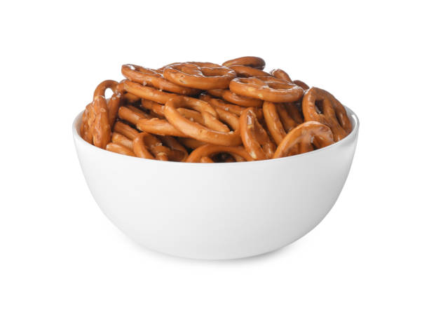 istock Delicious pretzel crackers in bowl isolated on white 1358323951
