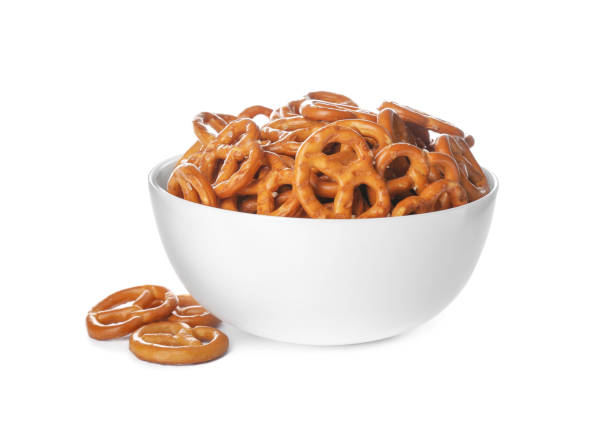 istock Delicious pretzel crackers in bowl isolated on white 1358324085