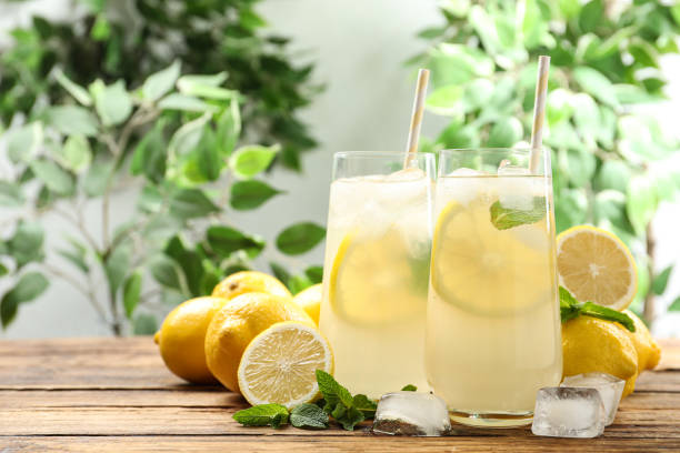 istock Natural lemonade with mint on wooden table, space for text. Summer refreshing drink 1358324695