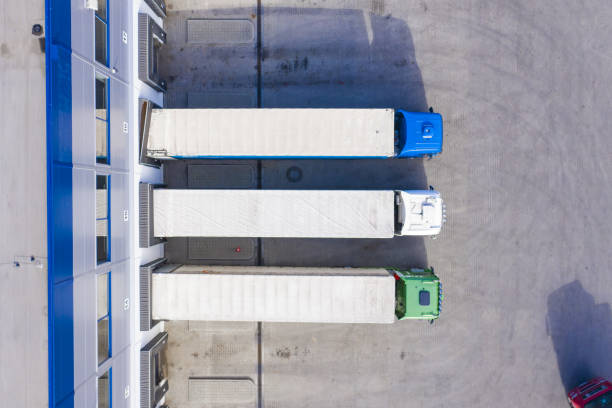 istock Big distribution warehouse with gates for loads and trucks. Aeri 1358325887