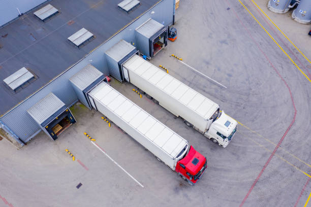 istock Aerial Shot of Industrial Warehouse/ Storage Building/ Loading 1358325902