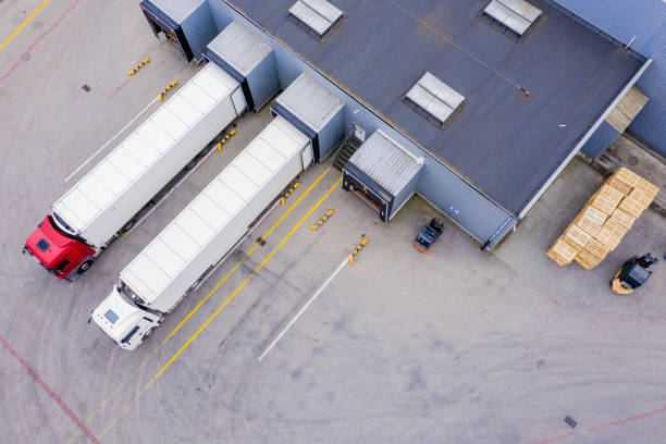 istock Aerial Shot of Industrial Warehouse/ Storage Building/ Loading 1358325904