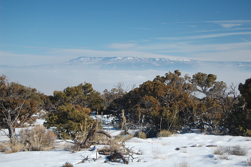 Grand mesa as seen through the fog from Colorado National Monument in January snow