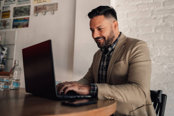 istock Businessman working on his laptop while drinking coffee in a cafe 1358331075