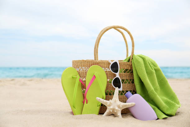 istock Different stylish beach objects and starfish on sand near sea 1358331193