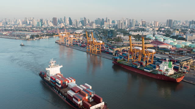 4K Time lapse or Hyper lapse : Aerial view Container Cargo ship at Terminal commercial port for business logistics, import export, shipping or freight transportation.