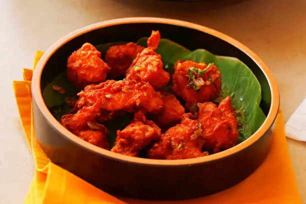 Photo of indian snack, spices marinated and deep fried tender chicken cubes, known as chicken 65