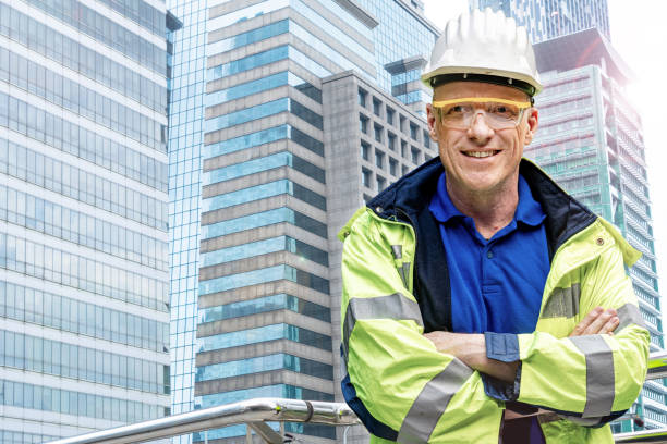 istock Factory senior engineer man standing confidence in front of building facade. construction workers for modern architecture in a city. 1358334905