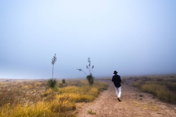 istock Man Hiking Foggy West Texas Grasslands 1358342436