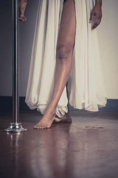 Female pole dancer of color Women of color pole dancing. Pole dance is both exotic and athletic. Strength and grace are required to create beautiful lines and shapes as a pole dancer and aerialist. black pole dancers stock pictures, royalty-free photos & images