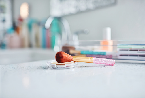 Make-up in plastic containers in bright modern bathroom