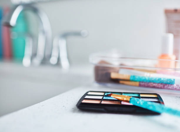 istock Make-up collection and eye-shadow palette in plastic containers in bright modern bathroom 1358349880