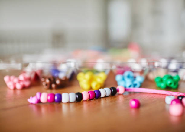 Cute toys and decor made of colorful aqua beads top view web banner