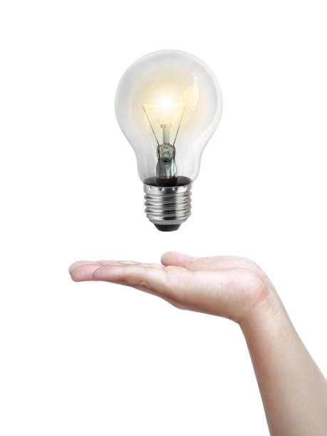 istock Light bulb in hand,Realistic photo image. Turn on tungsten light bulb with hand, isolated on white background 1358352600