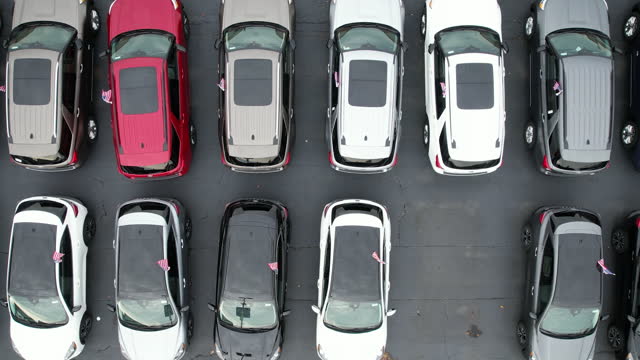 Rows of Brand New Car in an American Dealerships Stock Aerial View.