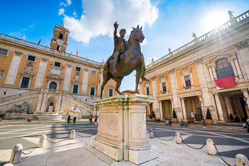 Rome, Italy, October 16 -- A view of the majestic equestrian statue of Emperor Marcus Aurelius located in the center of Piazza del Campidoglio (Roman Capitol Square), in the historic core of the Eternal City. Located on the Capitoline Hill, a sacred place in the Ancient Rome, this square was designed by Michelangelo in 1534. In the background, the ancient Palazzo Senatorio, actually seat of the municipal government of Rome. The original bronze statue of Marcus Aurelius is kept inside the Capitoline Museums. In 1980 the historic center of Rome was declared a World Heritage Site by Unesco. Super wide angle and high definition image.
