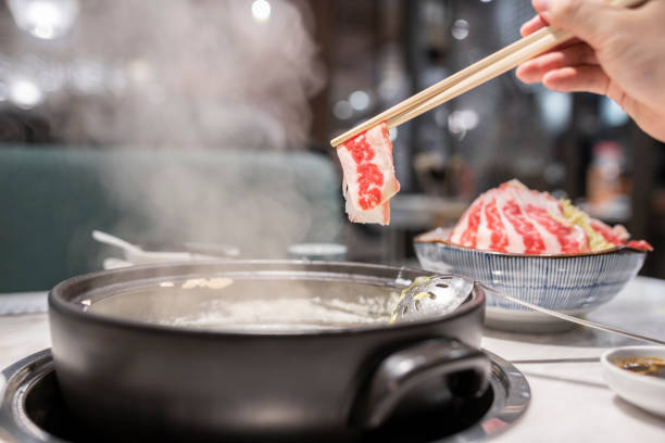 istock Cooking congee hot pot dish Slice of Beef 1358374233