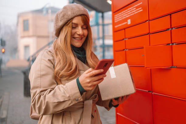 Woman received parcel using automated self-service post terminal machine