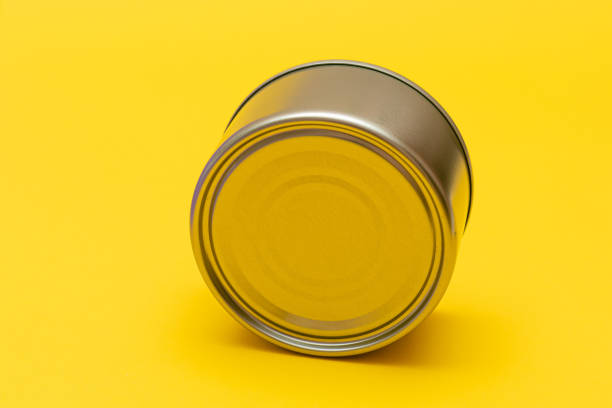 istock Unopened Tin Can with Blank Edge on Yellow Background 1358380568