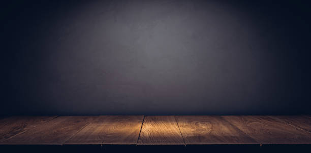 istock Oak plank podium or table in the dark with stone wall 1358383790