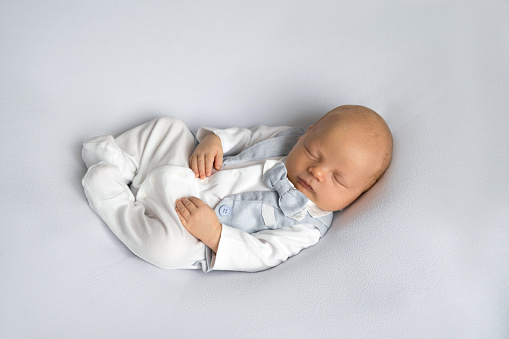 newborn baby boy sleeping on a gray background