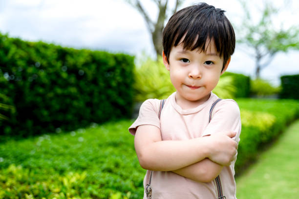 istock little boy cross arm. 1358385083