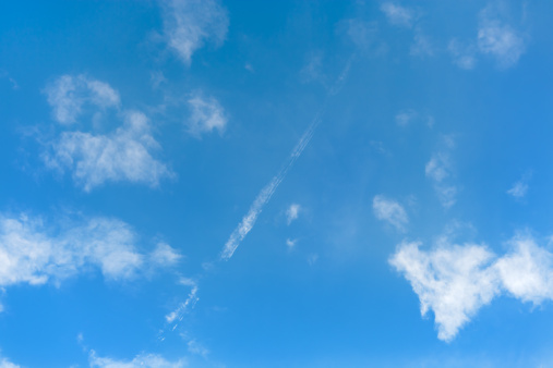 Blue sky with airplane trail
