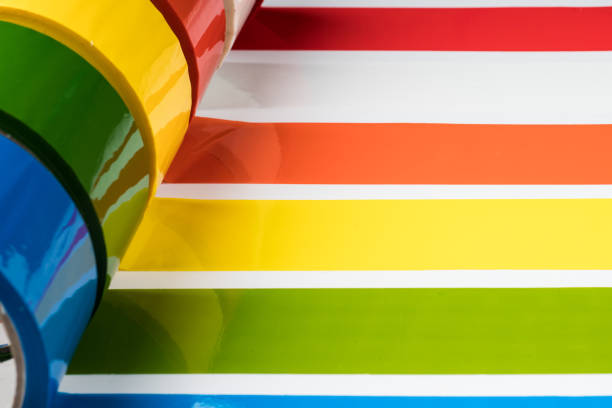 Colored adhesive tape rolls glued in stripes, selective focus