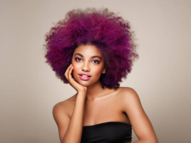 Beauty portrait of African American girl with afro hair Beauty portrait of African American girl with colorful dyed afro hair. Beautiful black woman. Cosmetics, makeup and fashion pink hair stock pictures, royalty-free photos & images