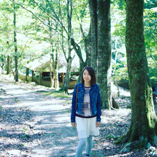 istock Young Woman Walking in Park. 1358395778