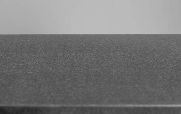 metal gray table surface for background copy-space on gray wall background.