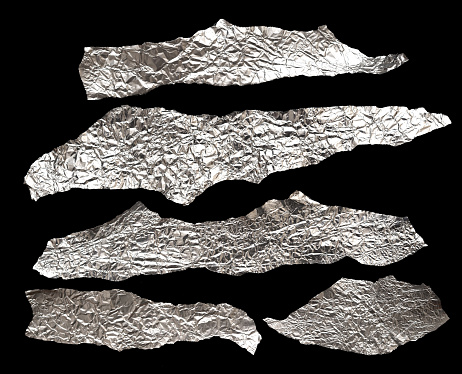 Pieces of foil on black background
