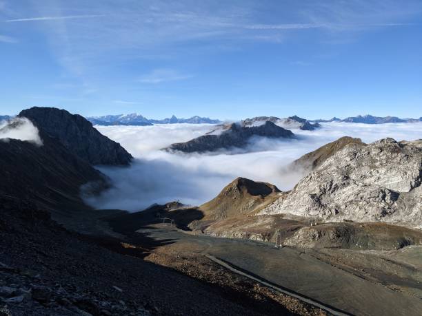 青い空の霧の海の上のパーセnnワイスフルヨッホからの早朝の眺め、スイスアルプスでのハイキングに良い一日 - weissfluhjoch ストックフォトと画像